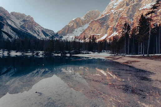 A serene mountain landscape captured during a quiet sunrise, reflecting the peaceful settings found in Hans-Ulrich Schlageter's travel writings.