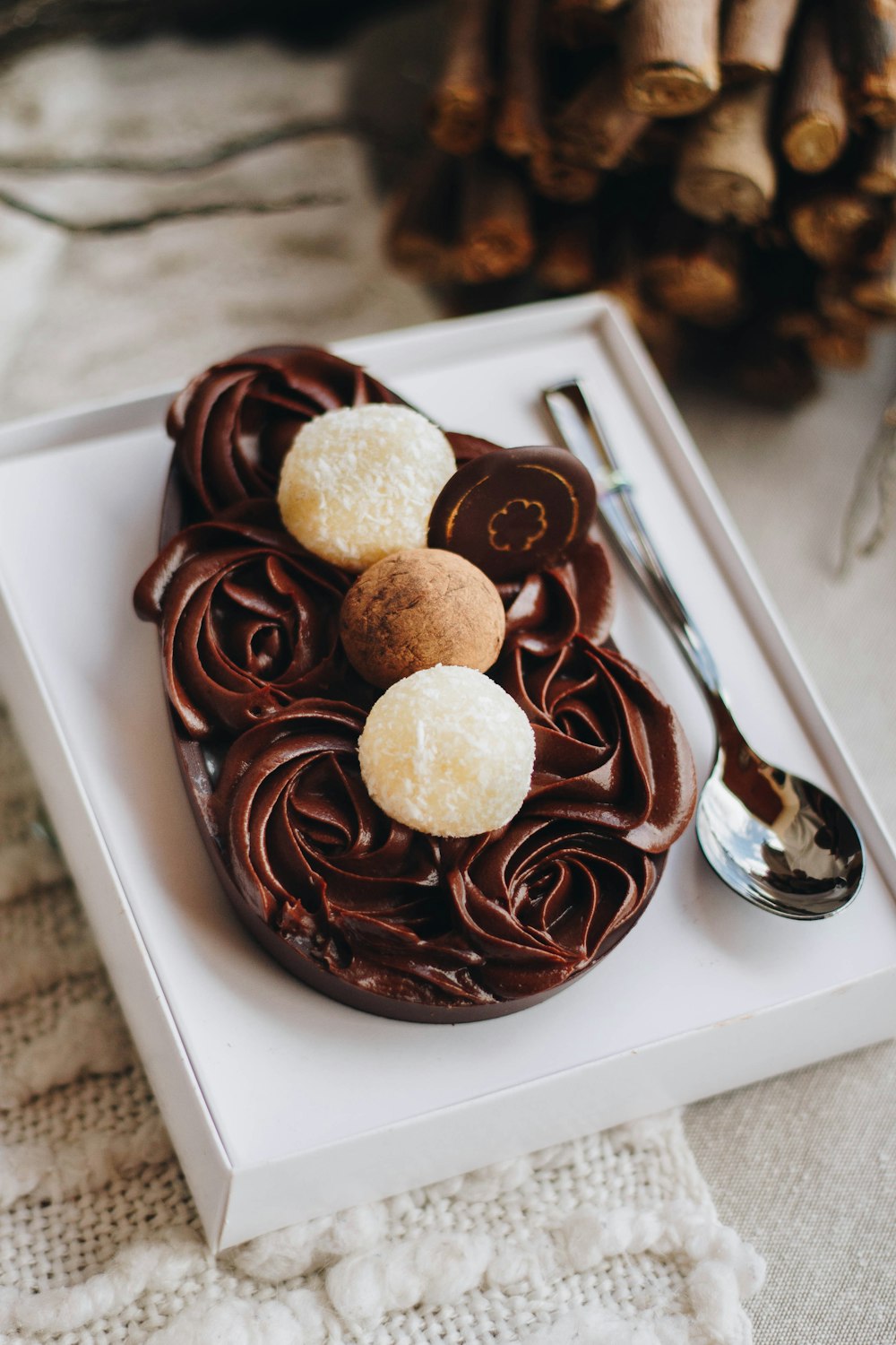 a white plate topped with a chocolate cake