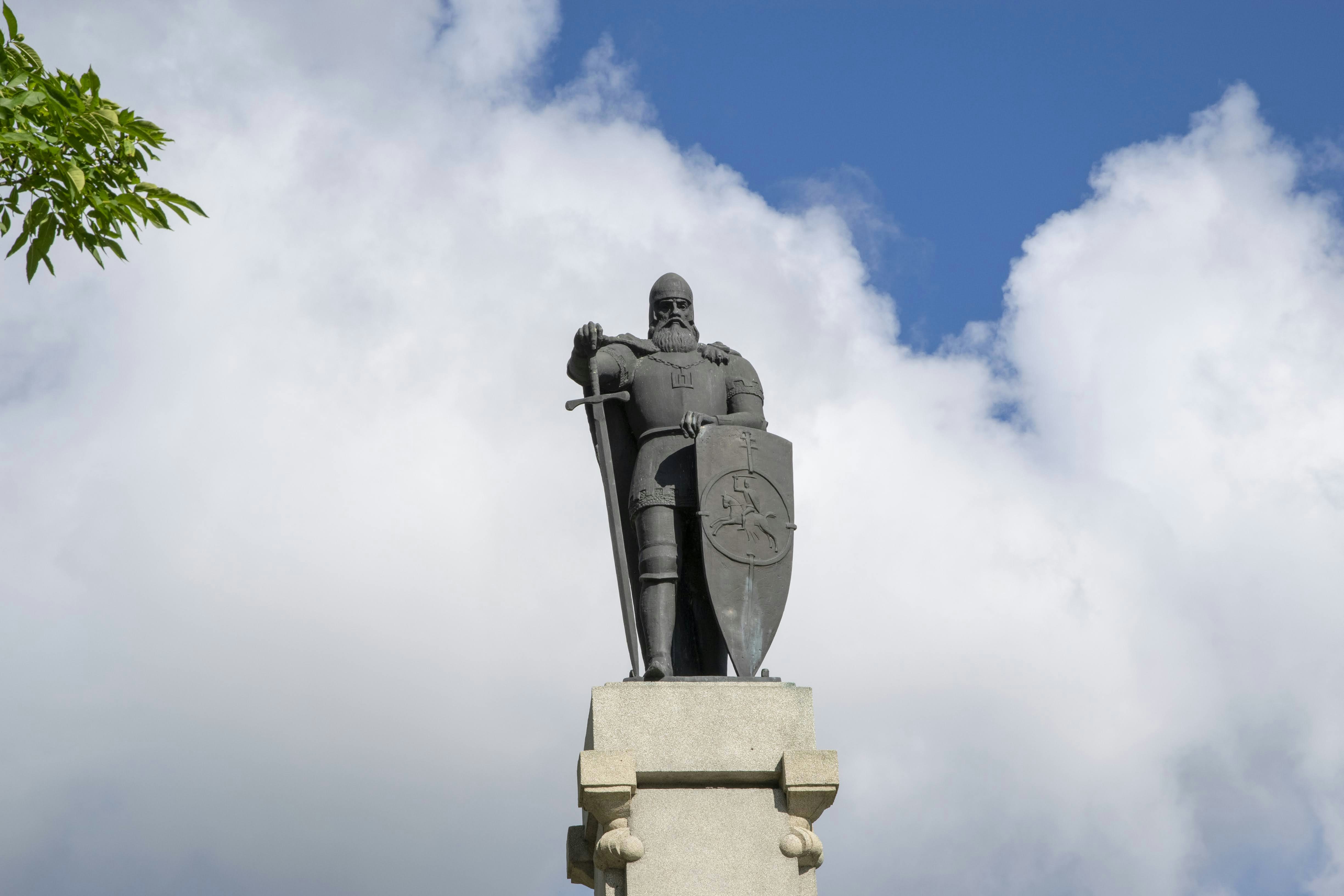 una estatua de un hombre sosteniendo un escudo y una espada
