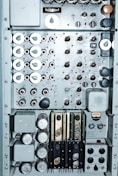 Close-up of a sleek control panel with glowing buttons and digital readouts in an industrial plant.