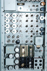 Close-up of a control panel with digital interfaces and wiring.