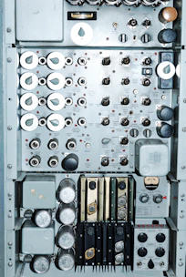 Close-up of industrial control panel with digital displays and switches.