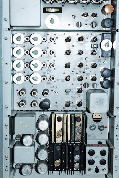 A close-up of a mechanical control panel with various gauges and switches.