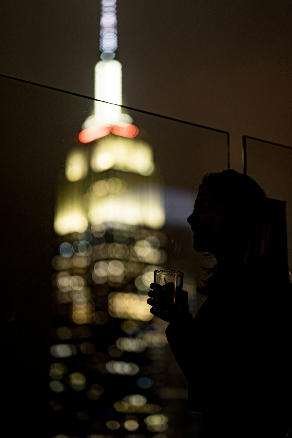 a person standing in front of a building at night