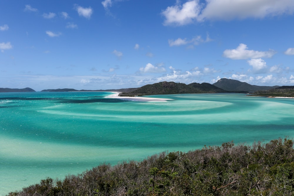 a view of a body of water with mountains in the background