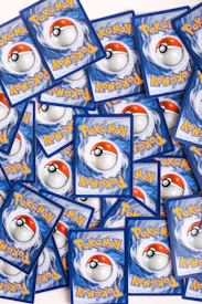 a pile of pokemon trading cards sitting on top of each other