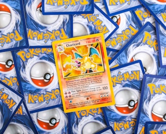 a pile of pokemon trading cards sitting on top of each other