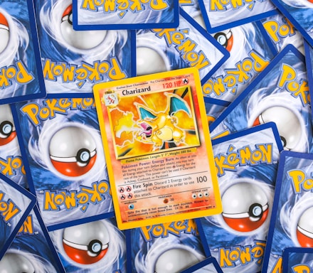 a pile of pokemon trading cards sitting on top of each other