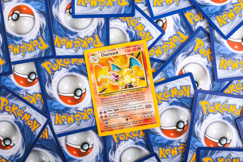 a pile of pokemon trading cards sitting on top of each other