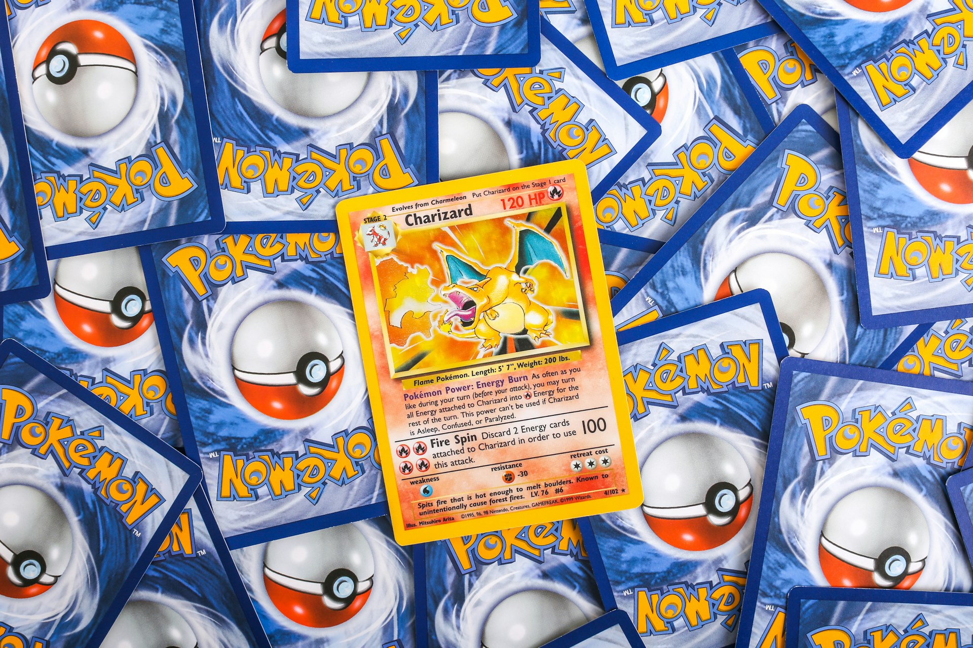 a pile of pokemon trading cards sitting on top of each other
