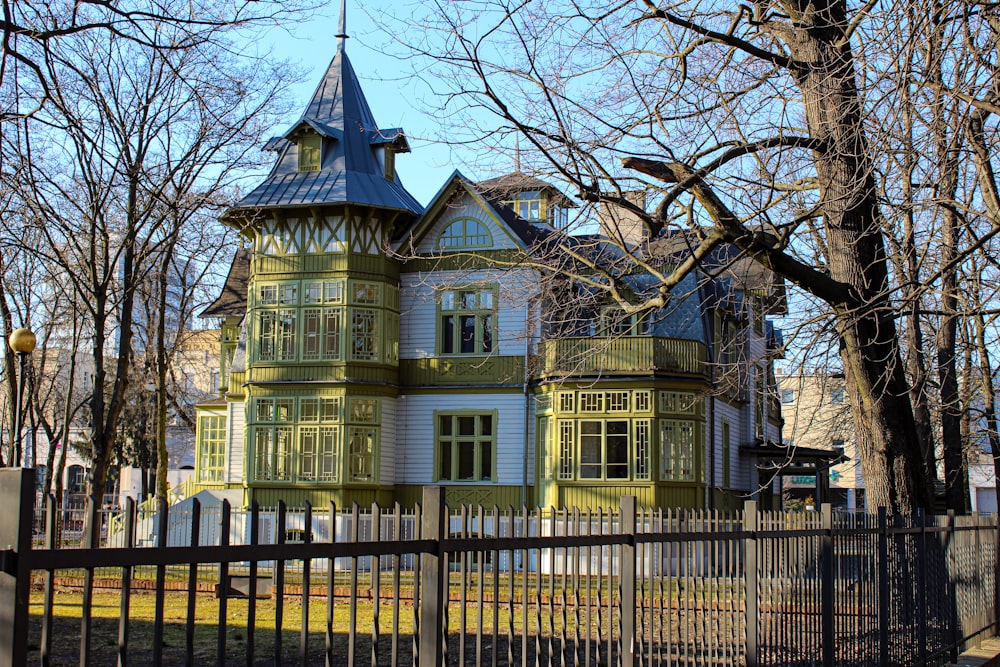 a large green house with a blue roof