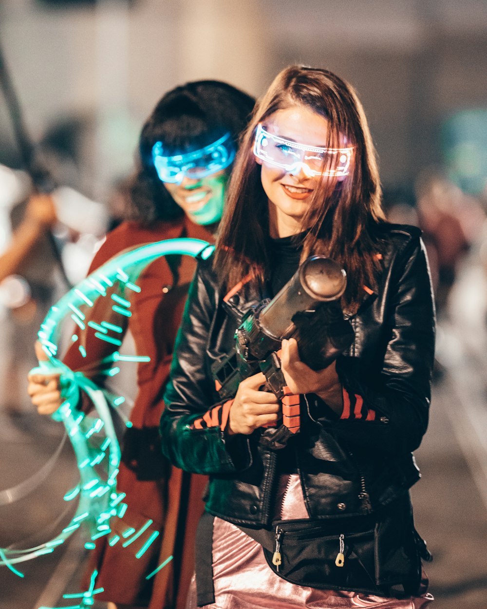 two people standing next to each other holding a camera