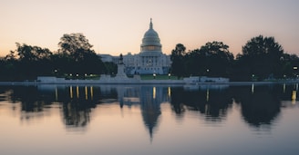 the capitol building is reflected in the water