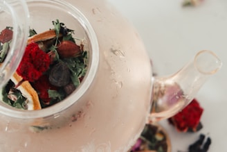 a tea pot filled with a mixture of herbs and flowers