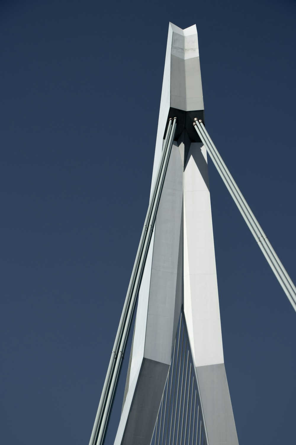 a view of the top of a bridge against a blue sky