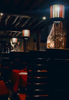 Cozy interior shot featuring traditional Vietnamese lanterns and colorful wall art at the restaurant.