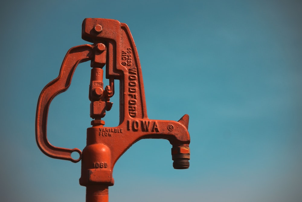 a red fire hydrant with a blue sky in the background