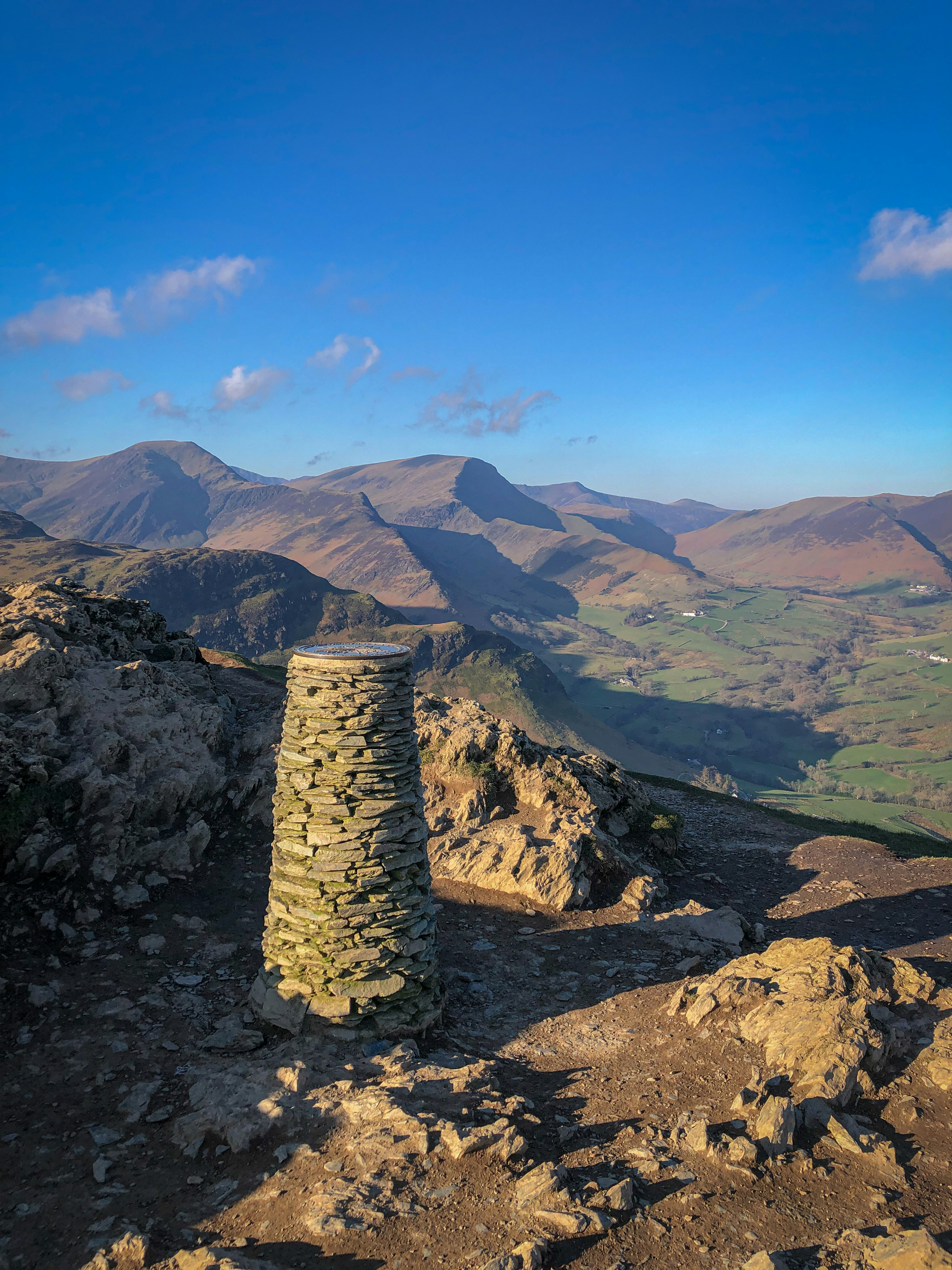 a stone pillar sitting on the side of a mountain