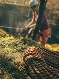 a man riding a bike next to a rope