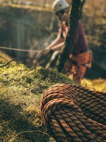 a man riding a bike next to a rope