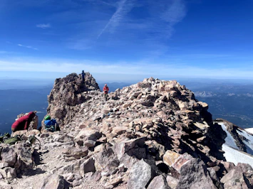 a group of people standing on top of a mountain