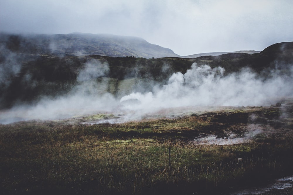 steam rises from the ground in a valley