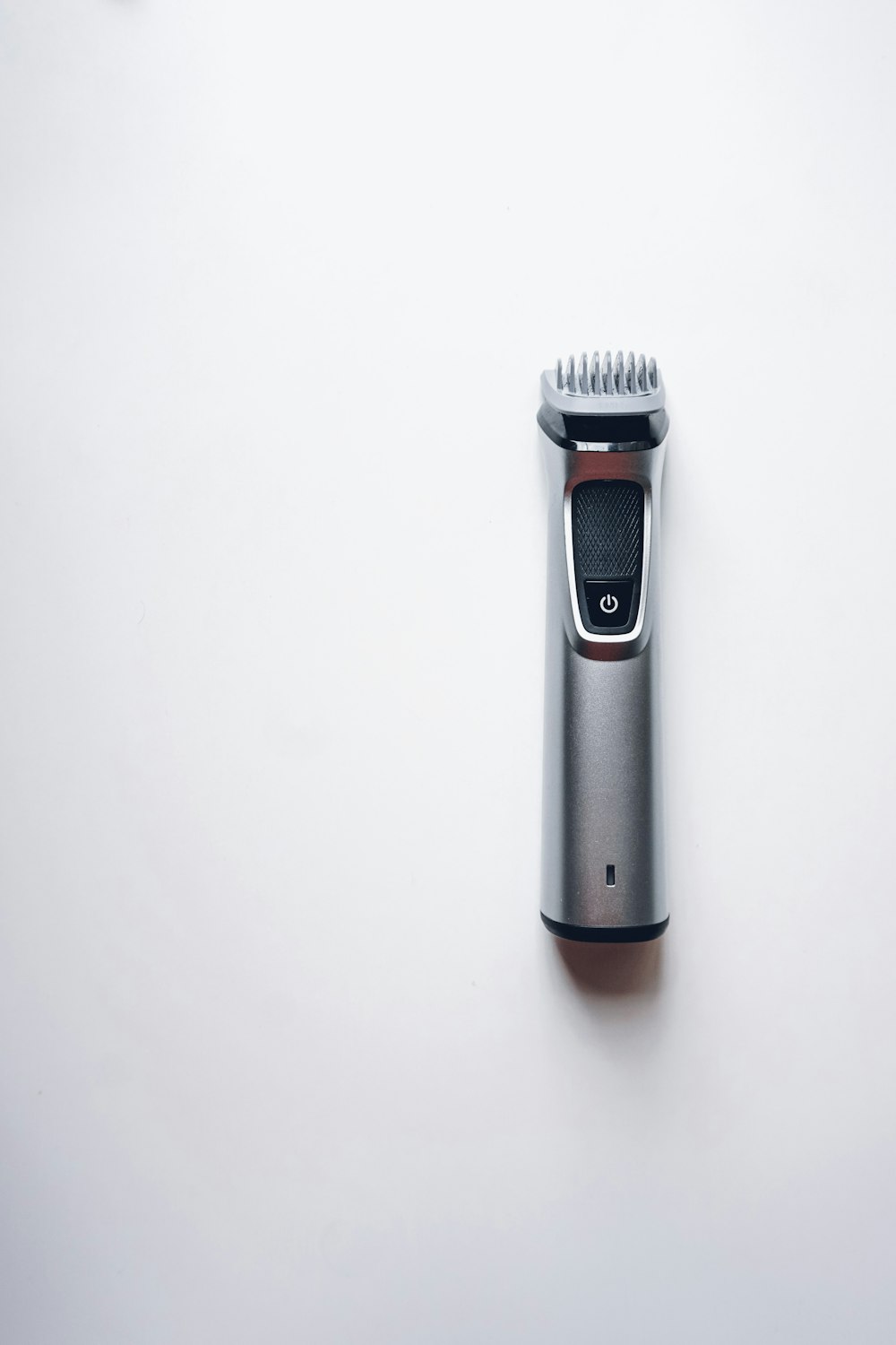 a close up of a hair clipper on a white surface