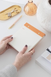An organized workspace featuring a notebook and a pen.
