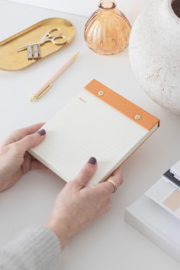 A cozy workspace with stationery supplies and a notepad.