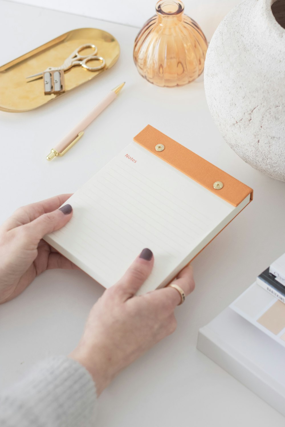 a woman is holding a notepad in her hand