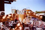 Guests enjoying a sunny outdoor champagne reception with live music playing softly