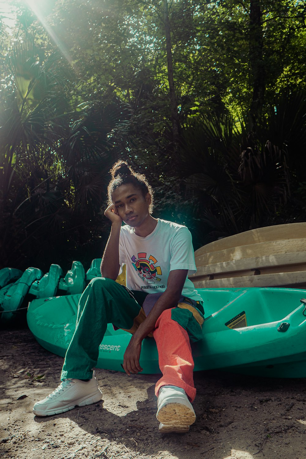 a man sitting on a raft in the sand