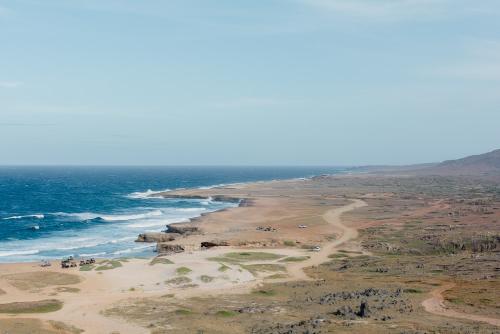 a view of a beach and ocean from a hill