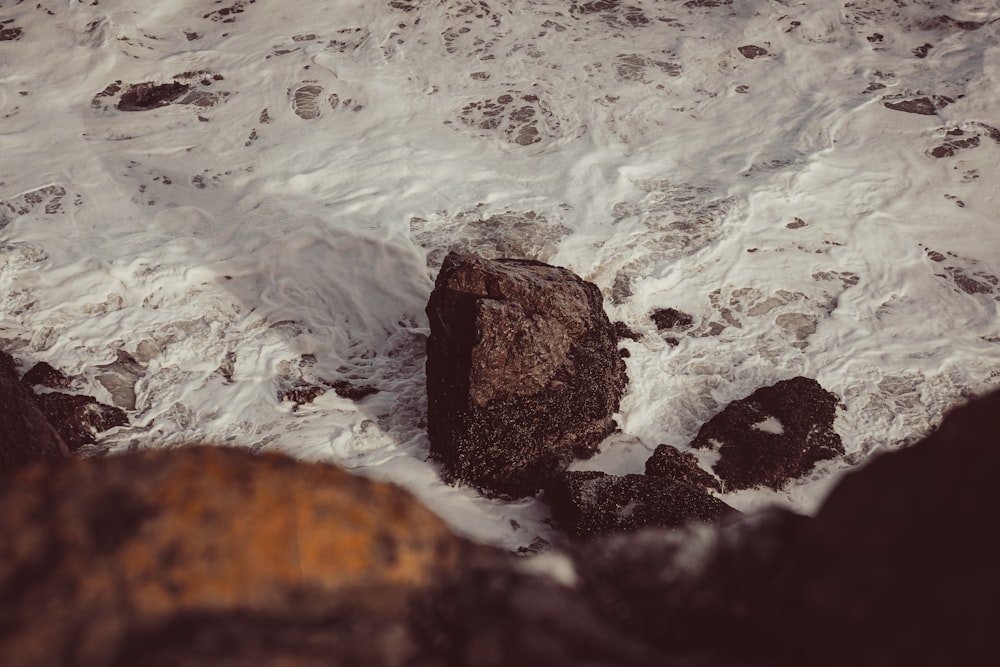 a rock in the middle of a body of water