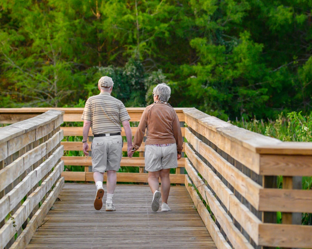 a couple of people that are walking across a bridge