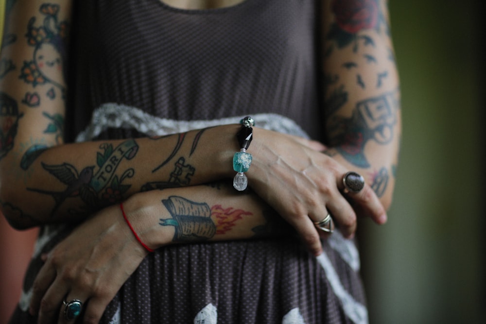 a woman with tattoos on her arm and arm