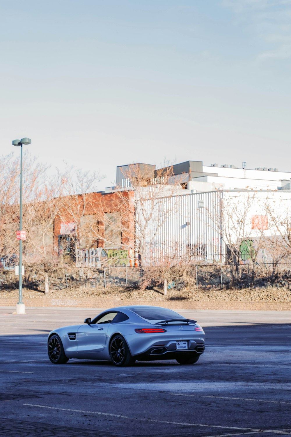 a silver sports car parked in a parking lot