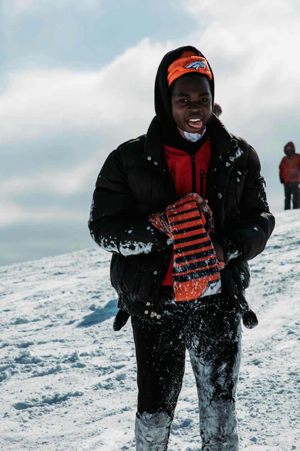 a man standing on top of a snow covered slope