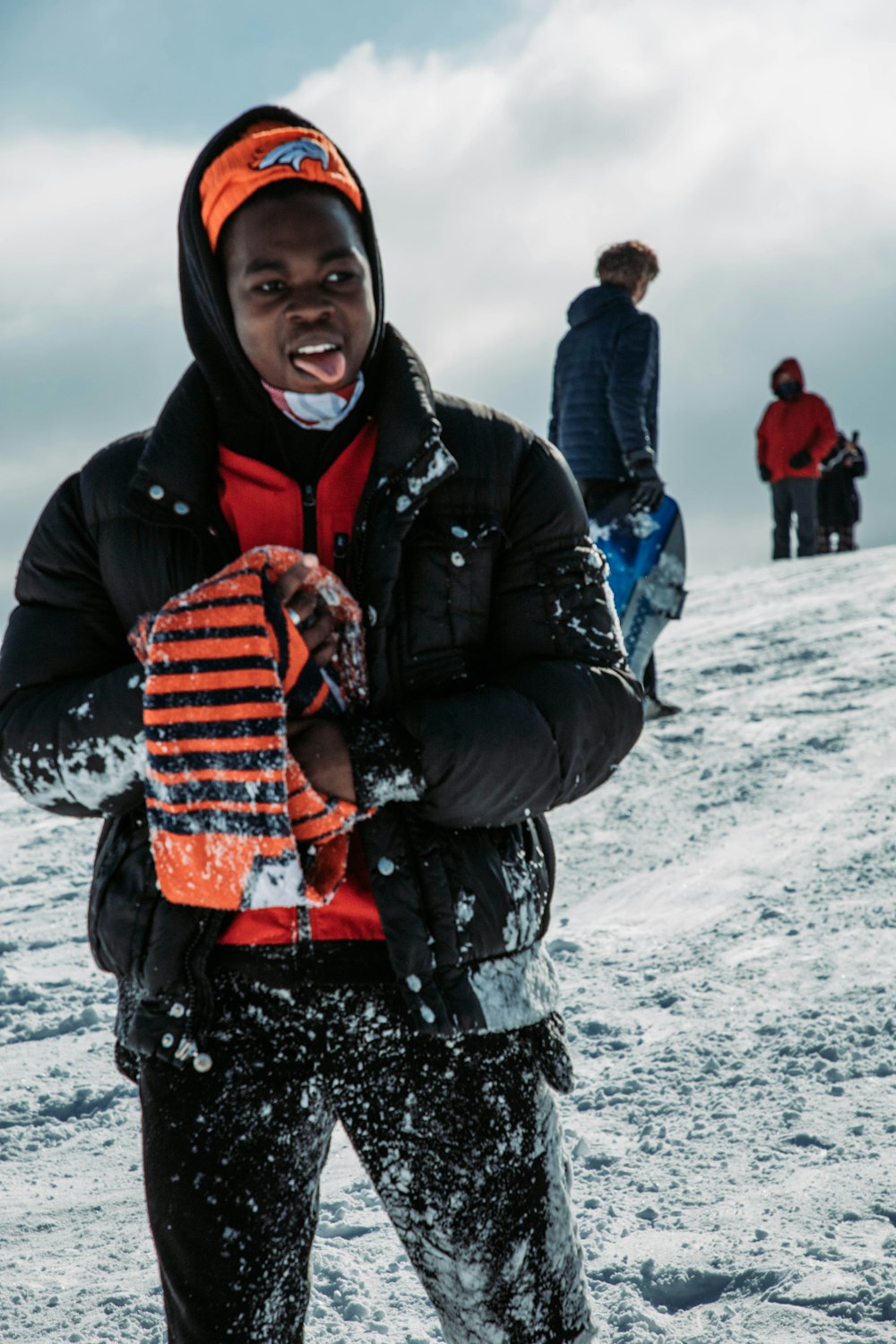 a man standing on top of a snow covered slope