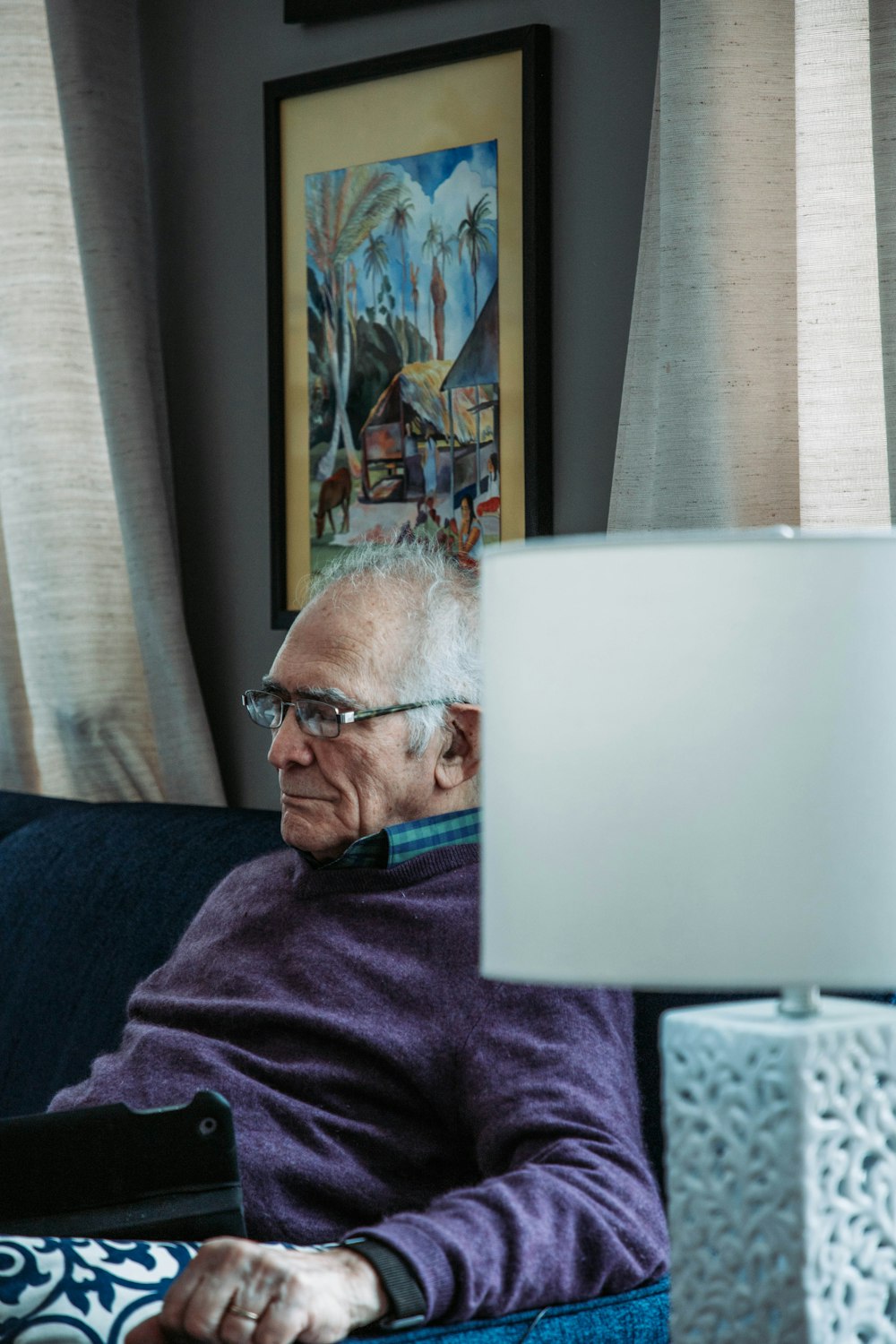 a man sitting on a couch using a laptop computer