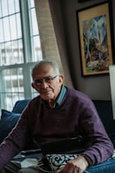 a man sitting on a couch with a tablet