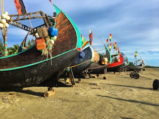 Traditional fishing boats lined up on the beach in Ratnagiri.