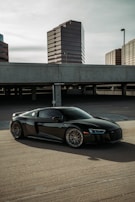 a black sports car parked in a parking lot