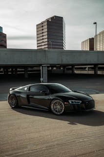 a black sports car parked in a parking lot