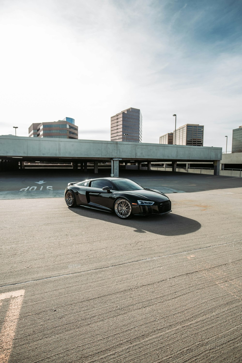 a black sports car parked in a parking lot