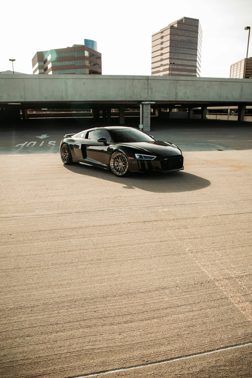 a black sports car parked in a parking lot