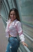 a woman is posing for a picture on a bridge