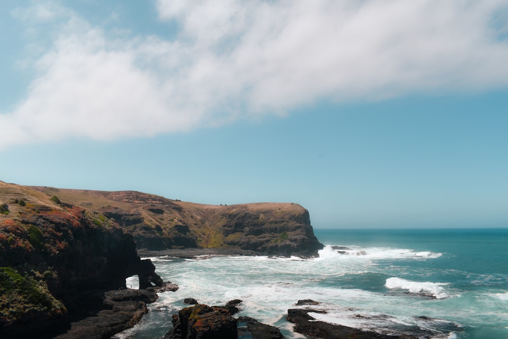 a rocky cliff overlooks a body of water