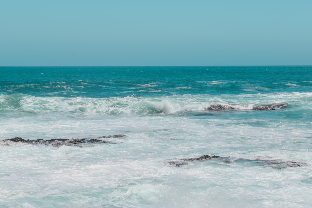 a man riding a surfboard on top of a wave in the ocean