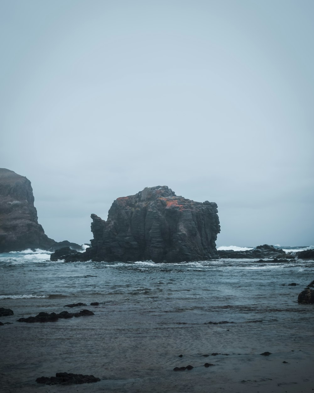 a rock outcropping in the middle of the ocean